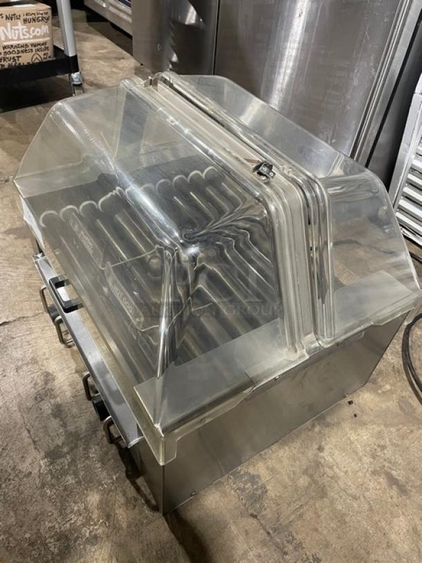 Star Model 258 stainless steel hot dog roller with clear cover, electric powered, on legs, serial number 25024209.