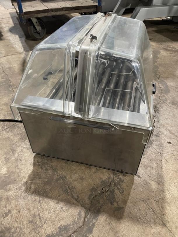 Star Model 258 Stainless Steel Hot Dog Roller with clear cover, on legs, electric-powered, 120V, SN: 25024209.