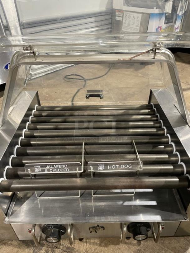 Star Model 258 stainless steel hot dog roller with clear cover, countertop design, electric powered, 120V, on legs.