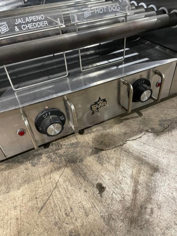 Star 258 commercial hot dog roller, stainless steel, electric, with clear cover, model 258, SN: 25024209, 120V, on legs.