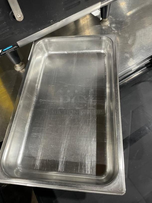 Commercial stainless steel hotel steam table pan, lightly scratched, durable, ideal for catering or restaurant use.