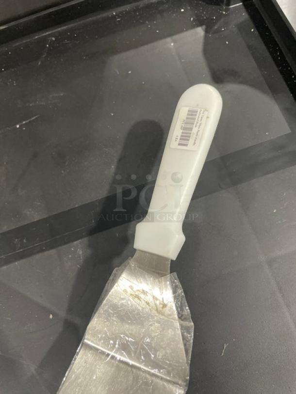ABC Commercial Stainless Steel Perforated Turner, Model PFT-10P, with white grip handle, excellent condition.