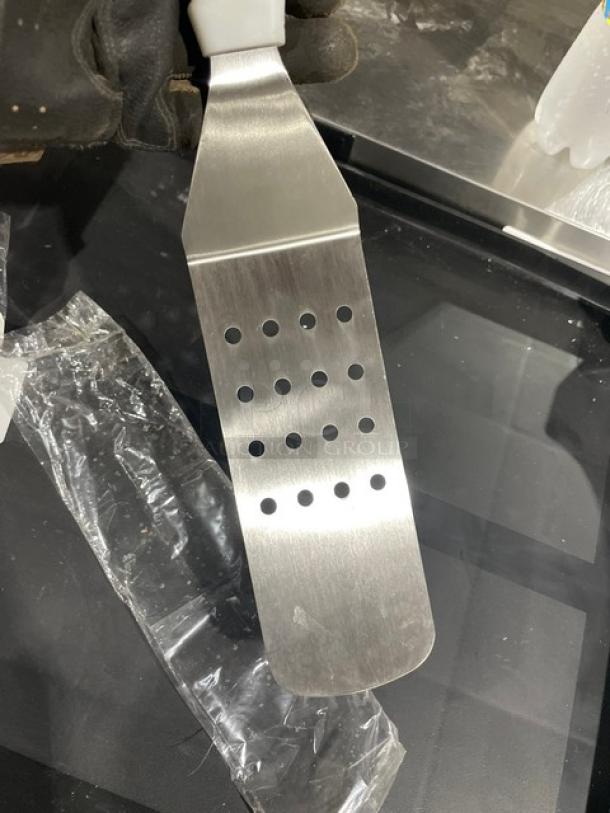 ABC Commercial Stainless Steel Perforated Turner, Model PFT-10P, with white grip handle, new condition.