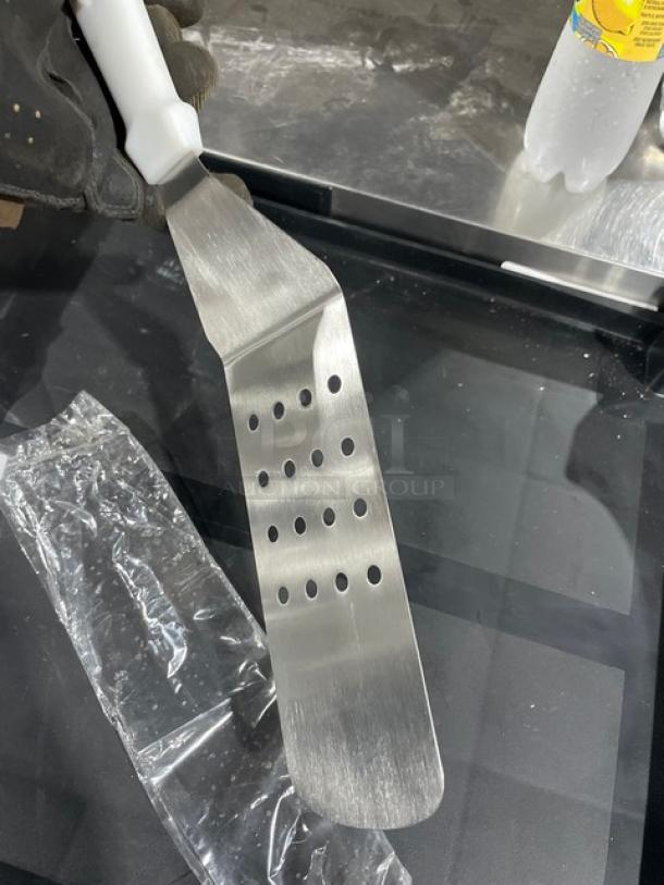 ABC Commercial Stainless Steel Perforated Turner, Model PFT10P, with white grip handle, excellent condition.
