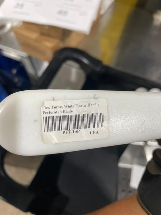 ABC PFT10P stainless steel perforated turner with white grip handle, featuring a model tag indicating "Flex Turner, Perforated Blade."
