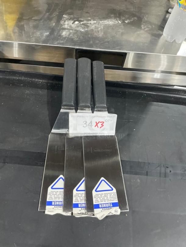 Brand new Dexter Russell commercial stainless steel turners, Model P94855, with black grip handles.