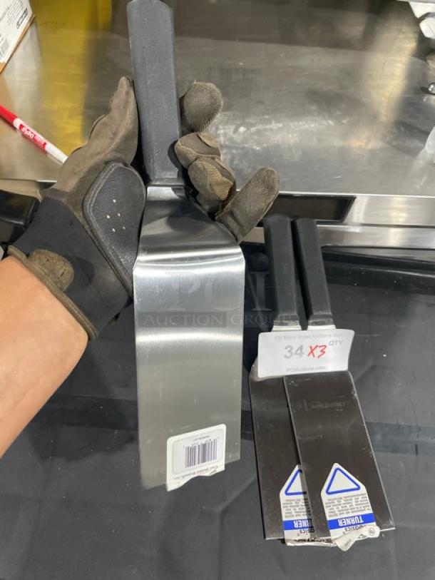 Brand new Dexter Russell P94855 stainless steel turner with black grip handle, SKU tag visible, pristine condition.