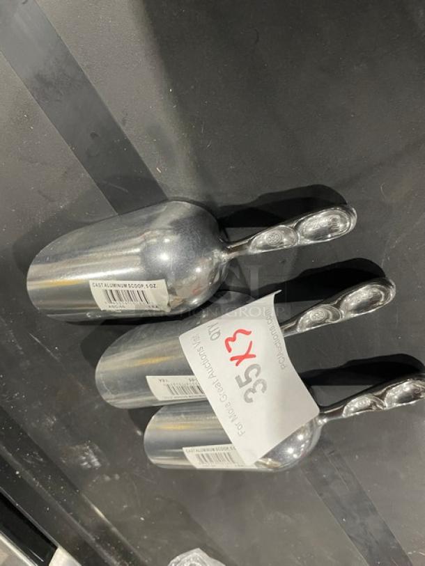 Brand new commercial cast aluminum 5 oz. scoops, Model ASC-05. Shiny finish, barcode visible. 3 scoops included.
