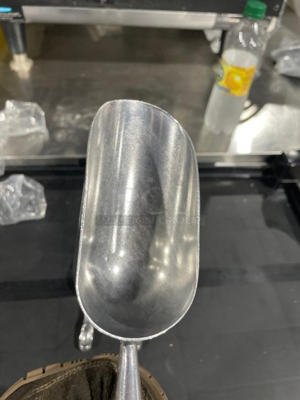 Brand new commercial cast aluminum 5 oz. scoop, model ASC-05, shiny finish, durable grip, suitable for food service.