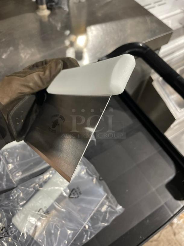 Brand new Jimmy John's stainless steel dough cutter with white grip handle, shown in packaging, with logo engraving.
