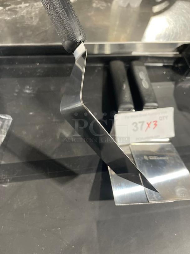 Dexter Russell Sani-Safe 4"x3" stainless steel hamburger turner, Model S286-4, with black grip handle, new condition.