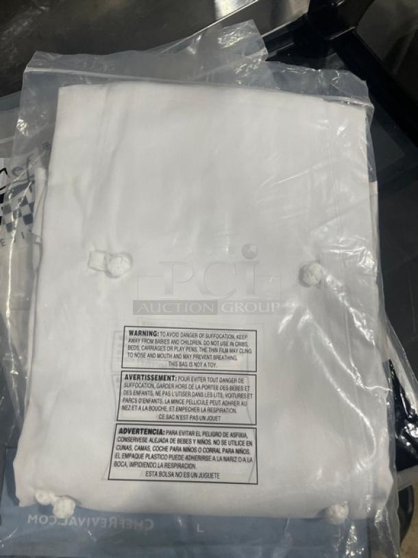 Brand new Chef Revival Ladies Knife & Steel Chef's Jacket in packaging. White, buttoned front, labeled with care instructions.