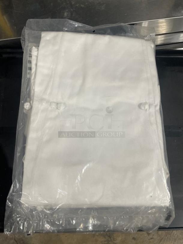 Brand new Chef Revival ladies' chef jacket in package. White, size 4X, secured with knot buttons.