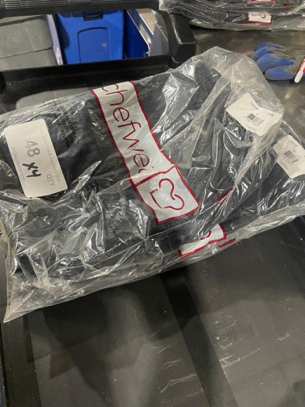 Brand new Chef Wear chef's pants in packaging. Includes four pairs. Clear packaging shows Chef Wear logo and size label.