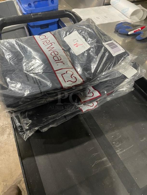 Brand new Chefwear chef pants, size medium, in plastic packaging. Includes seven pairs.