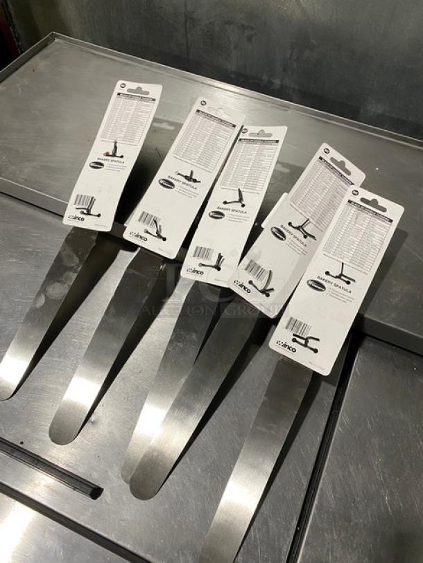 Brand new Winco Winware TKPS-9 bakery spatulas, stainless steel with black grip handles, displayed in original packaging.