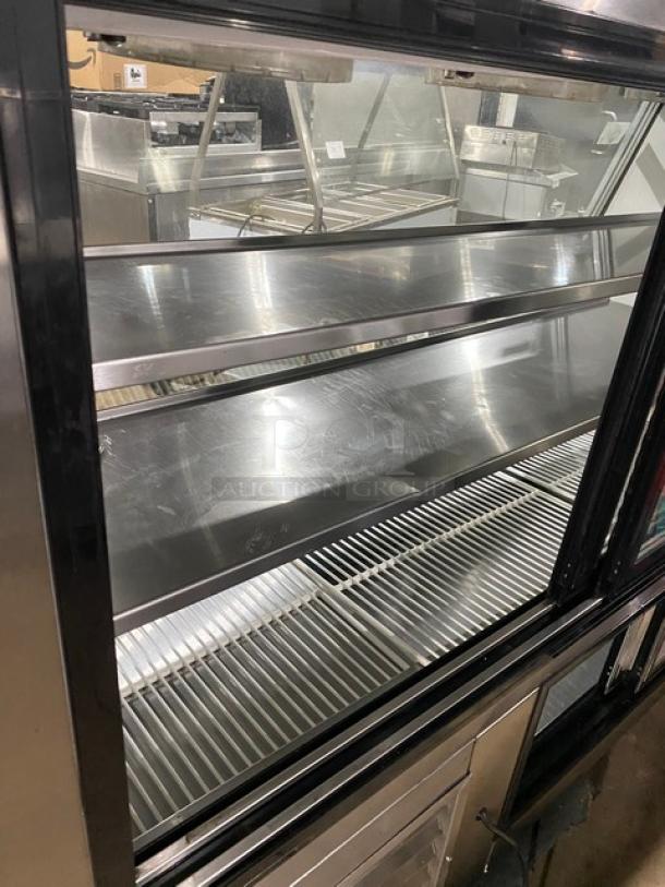Leader 2017 stainless steel 72" refrigerated deli display case, model HDL72FSC, with slanted glass and adjustable shelving.