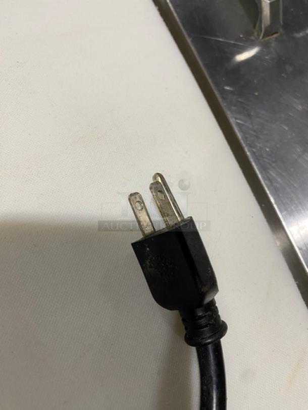 Close-up of a power plug for a Leader HDL72FSC refrigerated deli display cabinet, showing a standard three-prong connector.