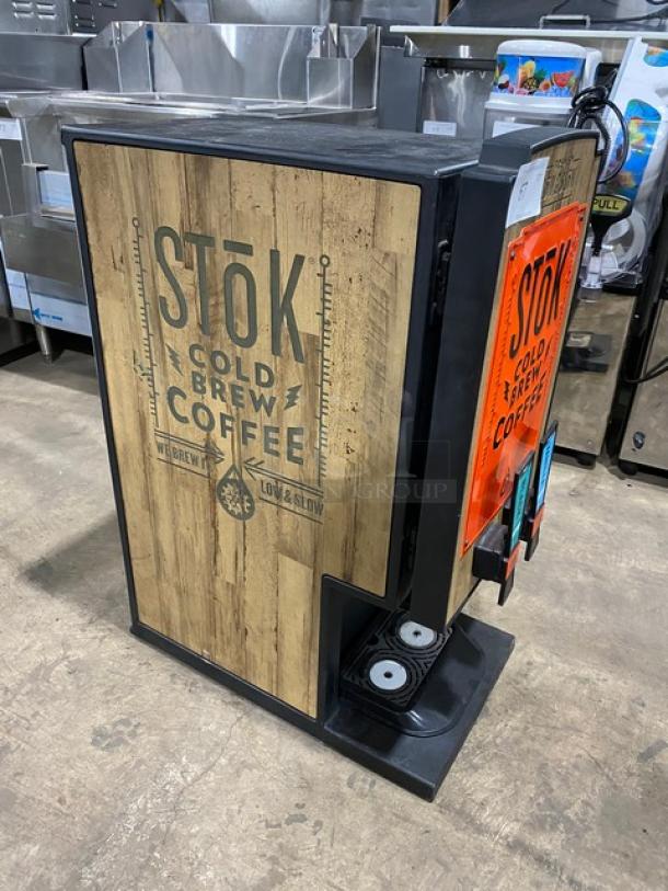 Creamiser Model 230 cold brew coffee dispensing machine with drip tray, 110V. Features a rustic wood-style exterior.
