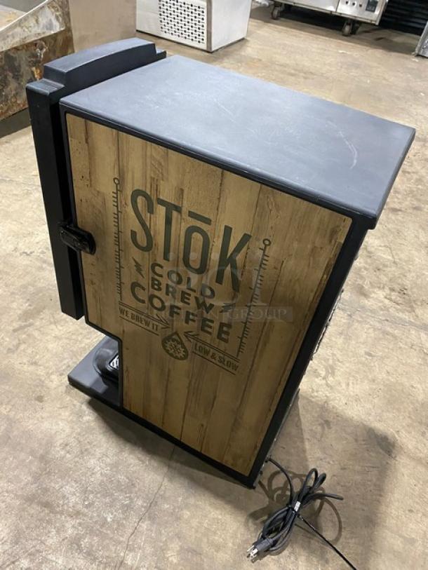 Creamiser Model 230 electric cold brew coffee dispenser with drip tray. Stōk branding on front. 110V power cord included.