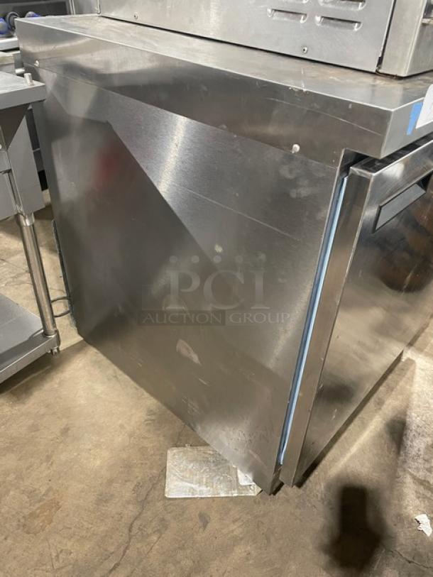 Delfield stainless steel single door under counter refrigerator with poly-coated wire rack, on casters, in used condition.