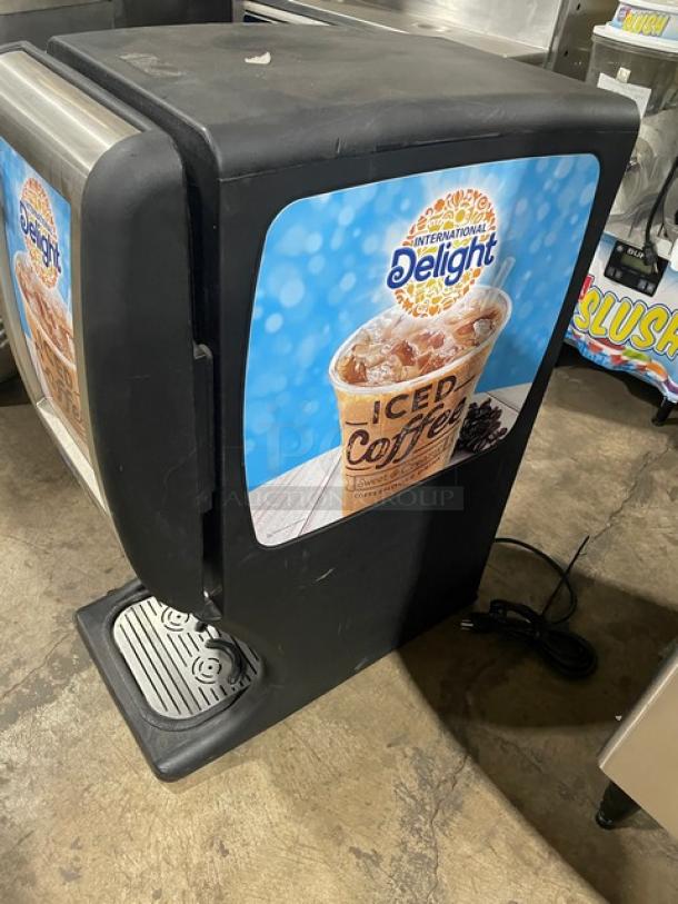 Creamiser Model 220 black countertop electric iced coffee dispenser, twin spouts, drip tray included, International Delight branding.