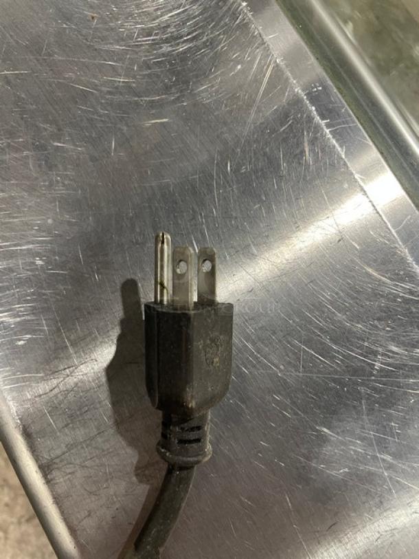 Close-up of electric plug for Hoshizaki Model HNC-150BA-R-S refrigerated sushi merchandiser.