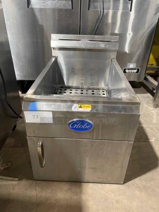 Globe commercial stainless steel gas countertop deep fat fryer with backsplash, basket hanger, visible brand logo.