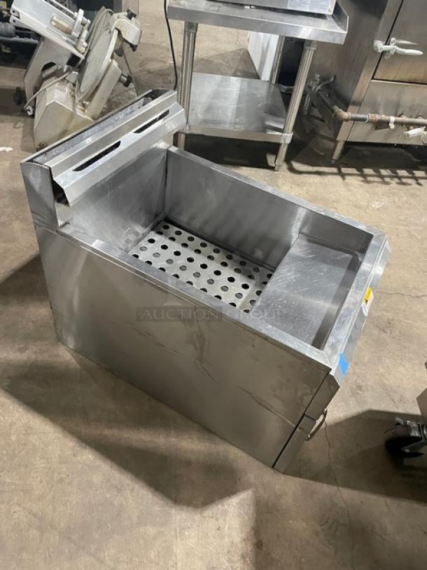 Globe stainless steel countertop deep fat fryer with backsplash, basket hanger. Natural gas powered, commercial use.