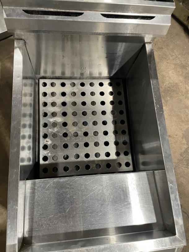 Globe stainless steel countertop deep fat fryer featuring natural gas power, backsplash, and basket hanger.