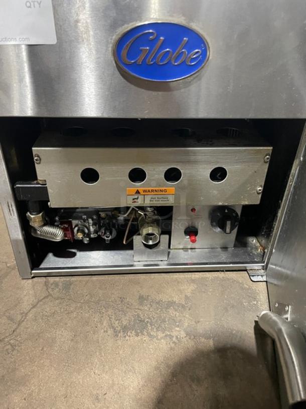 Globe Commercial Stainless Steel Natural Gas Countertop Fryer with backsplash and basket hanger. Visible warning label.