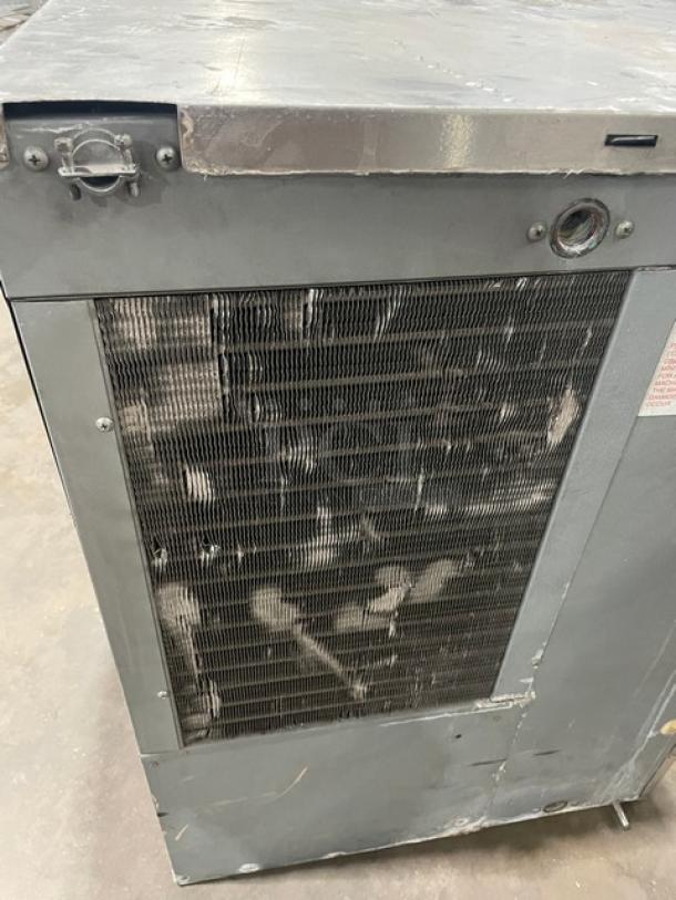 Hoshizaki KM-320MAH stainless steel ice maker, electric-powered, used condition, visible wear on exterior. Model details visible.