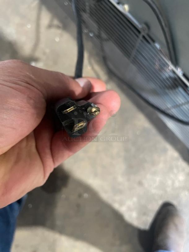Close-up of power plug for Asber ARF49 commercial freezer. Plug shows a standard three-prong configuration.