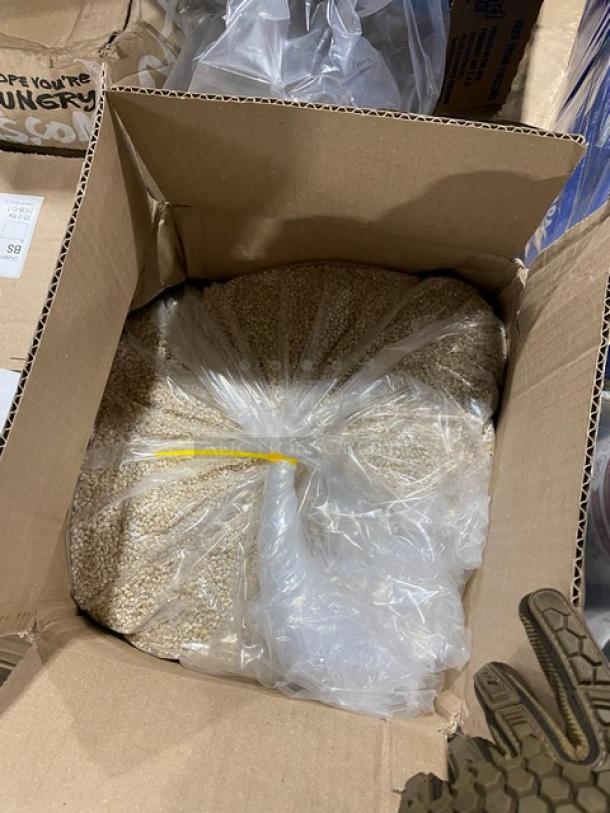 Mixed pallet with Kleenex commercial 2-ply tissues, 12 boxes per case, and assorted snack food/beverages in a cardboard box.
