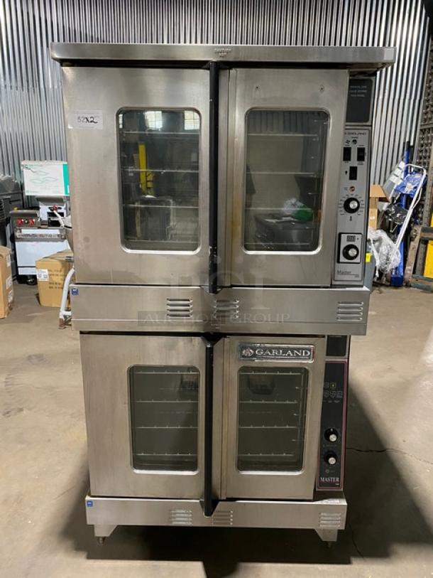 Garland Master Series stainless steel double-stacked convection oven, natural gas, thermostatic control, wired racks, on legs.