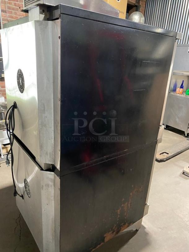 Garland Master Series stainless steel double-stacked convection oven. Natural gas-powered, thermostatic control, visible wear.