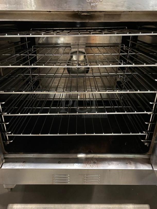 Garland Master Series stainless steel double-stacked convection oven with thermostatic control and wired racks, on legs.