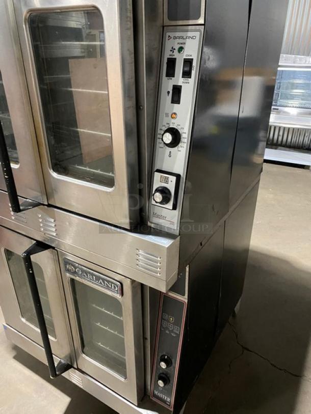Garland Master Series commercial double stacked convection oven, stainless steel, natural gas, thermostatic control, wired racks, on legs.