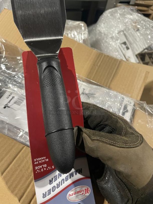 Brand new Winco TKP-61 stainless steel hamburger turner with black grip handle. Offset design, commercial-grade quality.