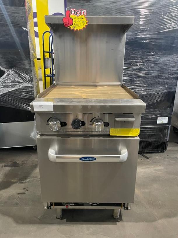 Brand new Atosa Cook Rite ATO-24G natural gas griddle with stainless steel overshelf and rack, on casters.