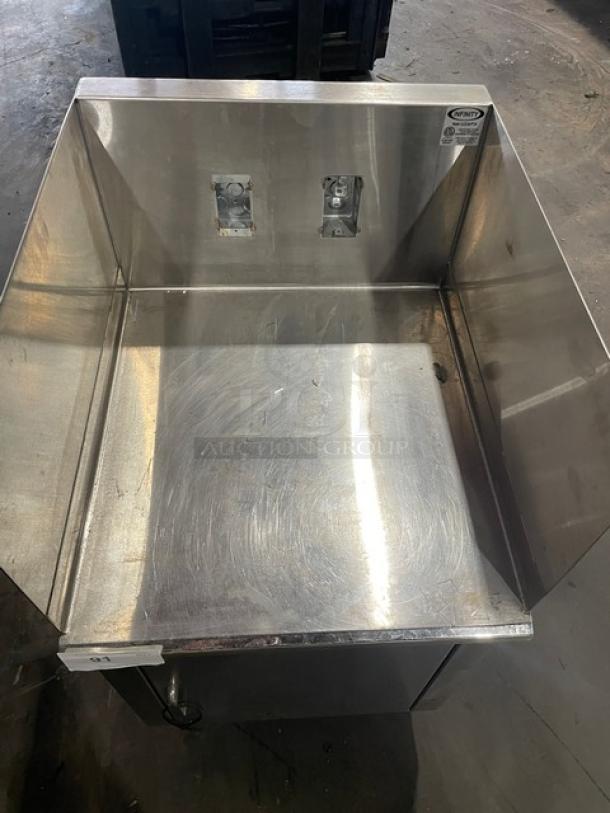 Infinity LCD-24-PT-M stainless steel base cabinet, custom-made, on legs, visible wear marks, Infinity label on top right.