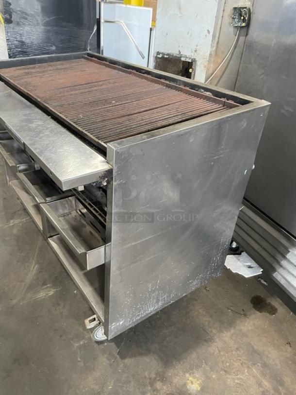 Bakers Pride F60R stainless steel charbroiler, natural gas, with cabinet base, work deck, grease drawer, water pans, on casters.