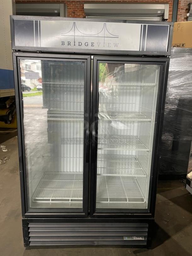 True commercial double glass door merchandiser freezer, black, model GDM-43F-HC~TSL01, with poly-coated wire racks.