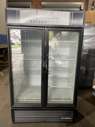 True commercial double glass door merchandiser freezer, black, model GDM-43F-HC~TSL01, with poly-coated wire racks.
