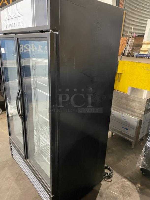 True commercial black double glass swing door reach-in merchandiser freezer, model GDM-43F-HC~TSL01, with poly-coated wire racks.