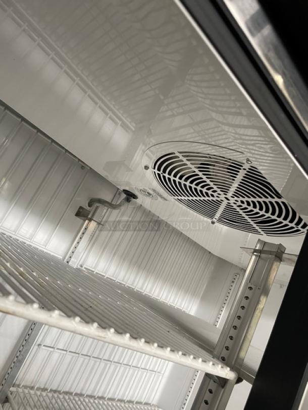 True GDM-43F-HC~TSL01 commercial freezer interior with poly-coated wire racks, fan, and shelving detail.