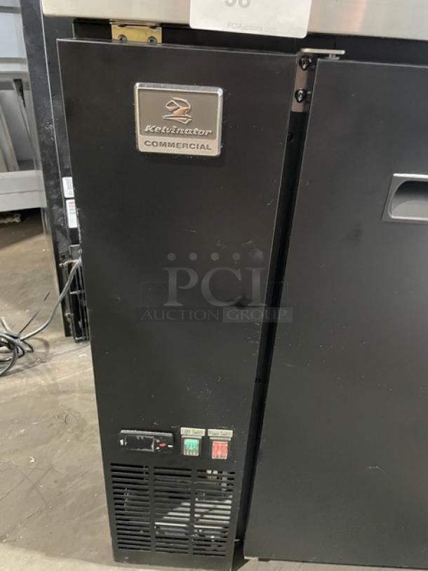 Kelvinator Commercial Black 2-Door 48" Back Bar Refrigerator, Model KCBB48SB-HC, with stainless steel worktop and poly coated wire racks.