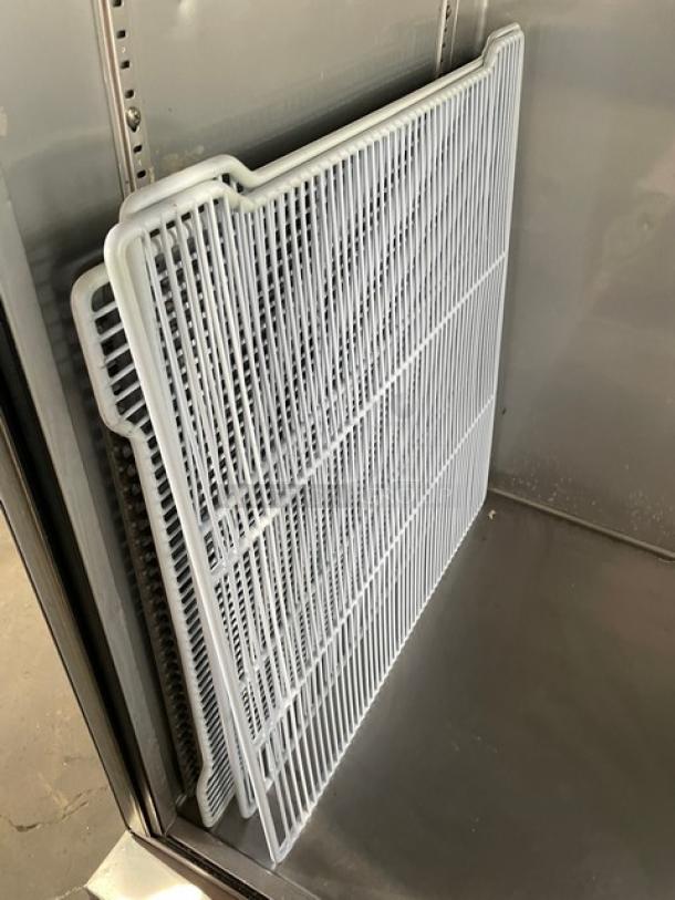 True Commercial T-23-HC refrigerator interior with poly-coated wire racks shown. Stainless steel construction, on casters.
