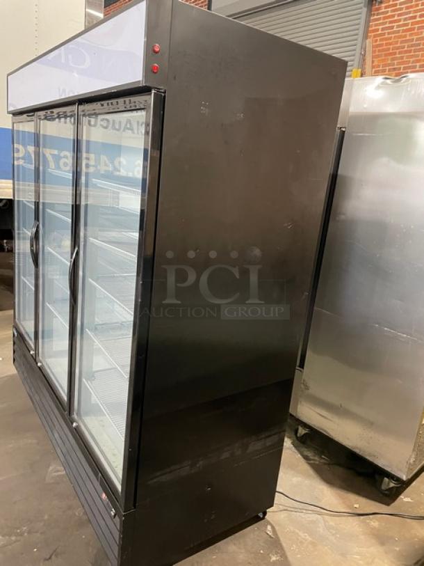 LIKE-NEW Kool-It 2020 black triple glass door merchandiser refrigerator with poly coated racks, model KGM-75, on casters.
