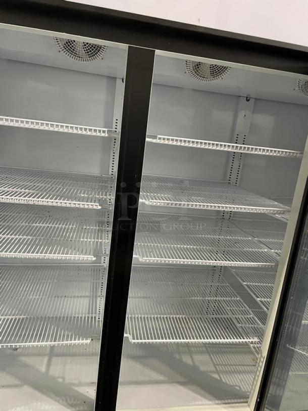 LIKE-NEW Kool-It KGM75 commercial refrigerator, black, triple glass swing doors, poly-coated wire racks, on casters.